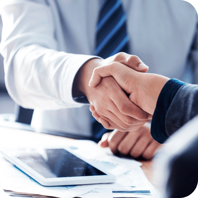 Shaking hands in business office